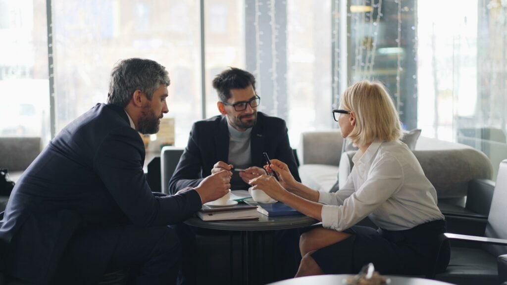 Advisers meeting around a table, representing AI tools for financial advice, meeting documentation and digital banking