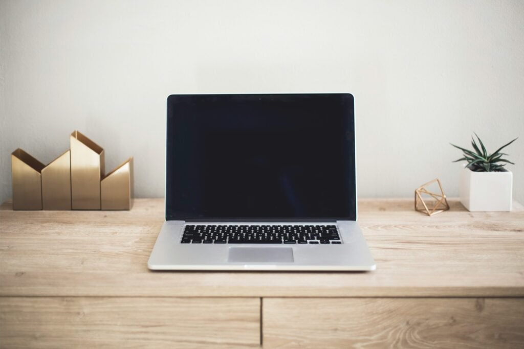 Best AI Tools for Job Seekers (2026): What Actually Works Laptop and notebook on a desk, representing AI tools for job seekers covering tracking, tailoring and interview preparation