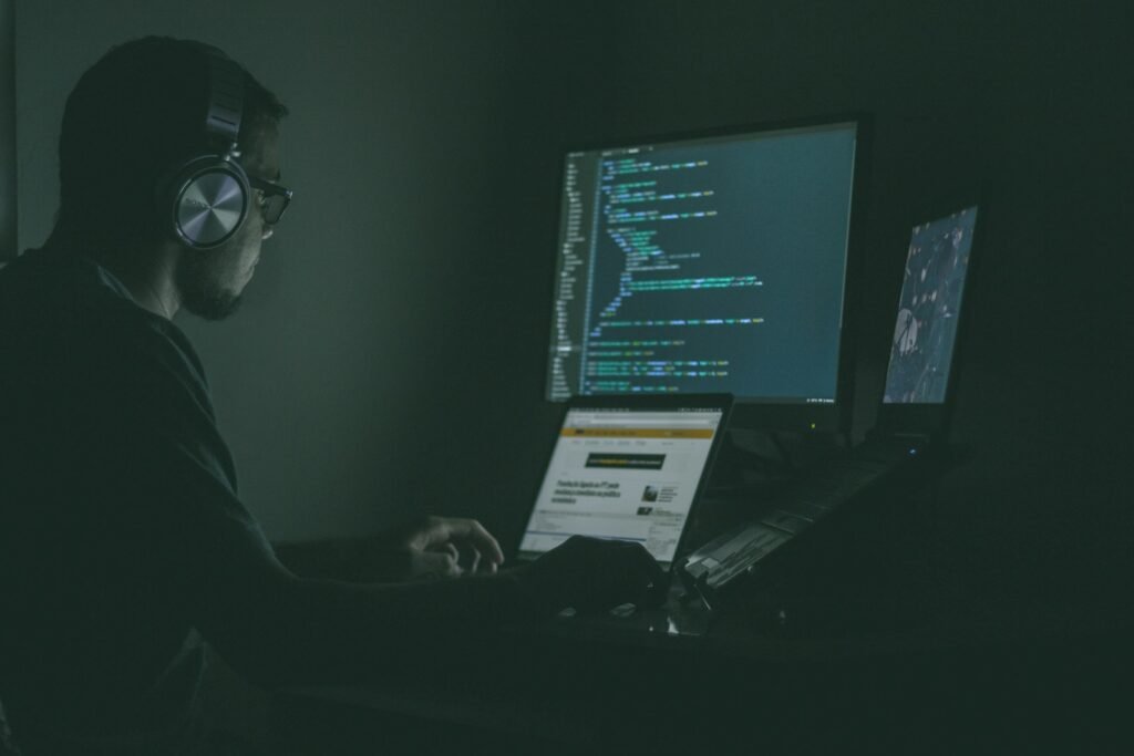 Best AI Tools for Vendor Risk & Threat Detection (2026) Security monitoring screens in a dark room, representing AI tools for vendor risk, email impersonation and anomaly detection