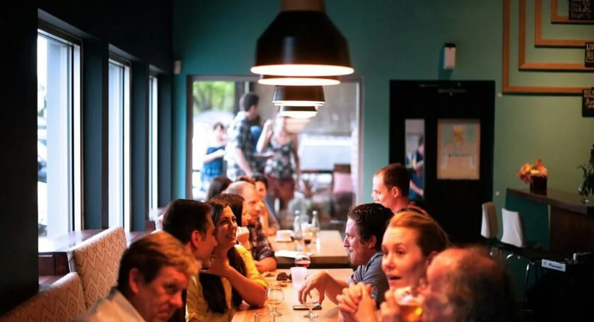 Busy dining room at peak service, when the best voice AI tools for restaurant efficiency answer reservation calls staff cannot reach