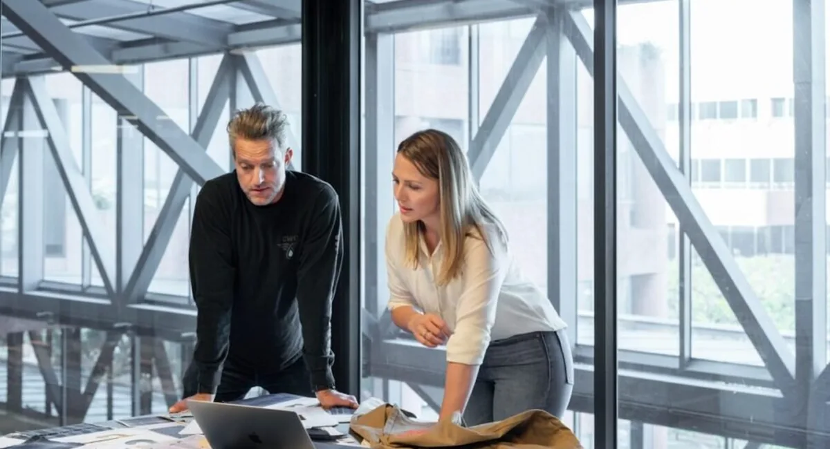 A sales meeting in an open-plan office, the kind of team decision behind choosing the best AI search monitoring tool for SEO professionals