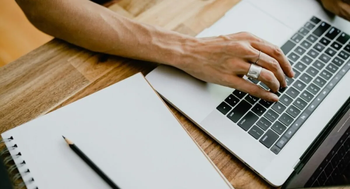 Person typing on a laptop, the manual rewriting work that the best AI tools for increasing visibility 2026 can measure but cannot do for you