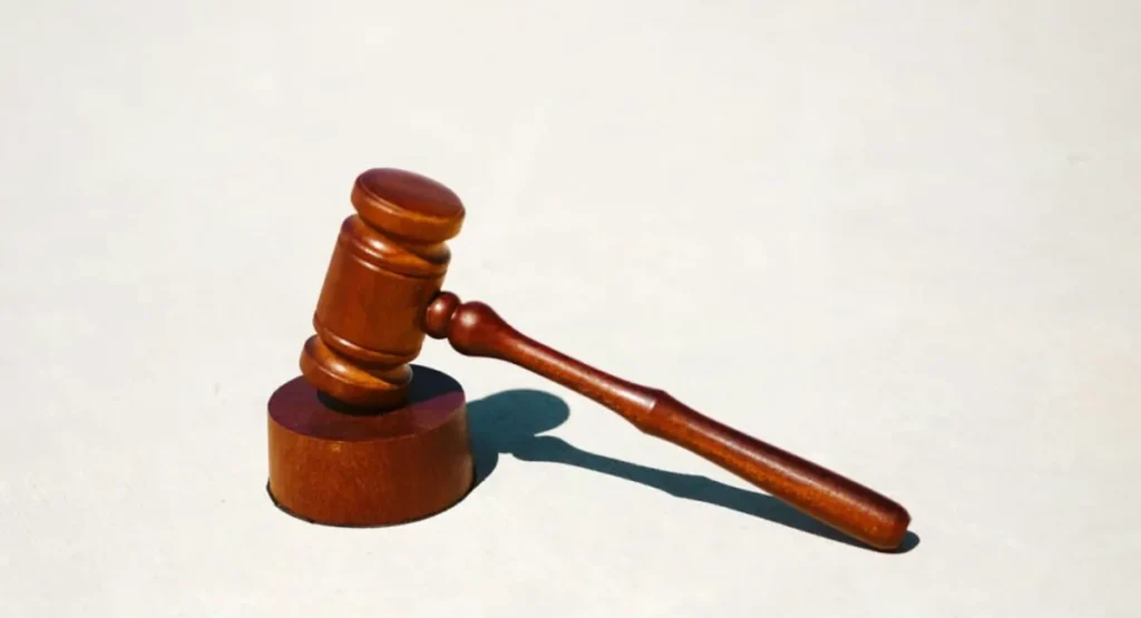 Wooden judge's gavel on a white surface, representing personal injury law practice