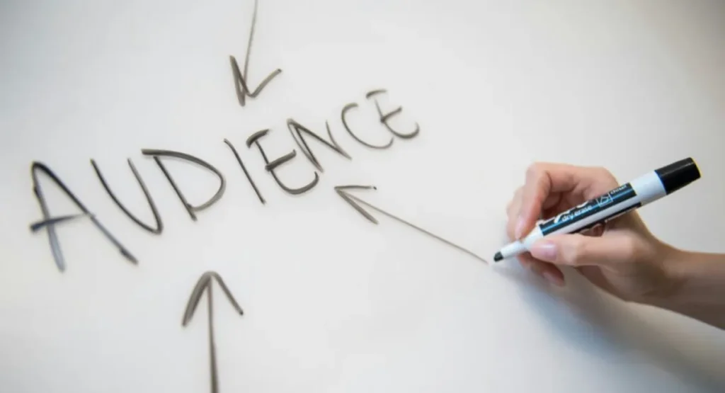 Best AI Tools for SEO Marketing 2026: 6 Compared Hand writing AUDIENCE with arrows on a whiteboard, planning SEO marketing with AI tools