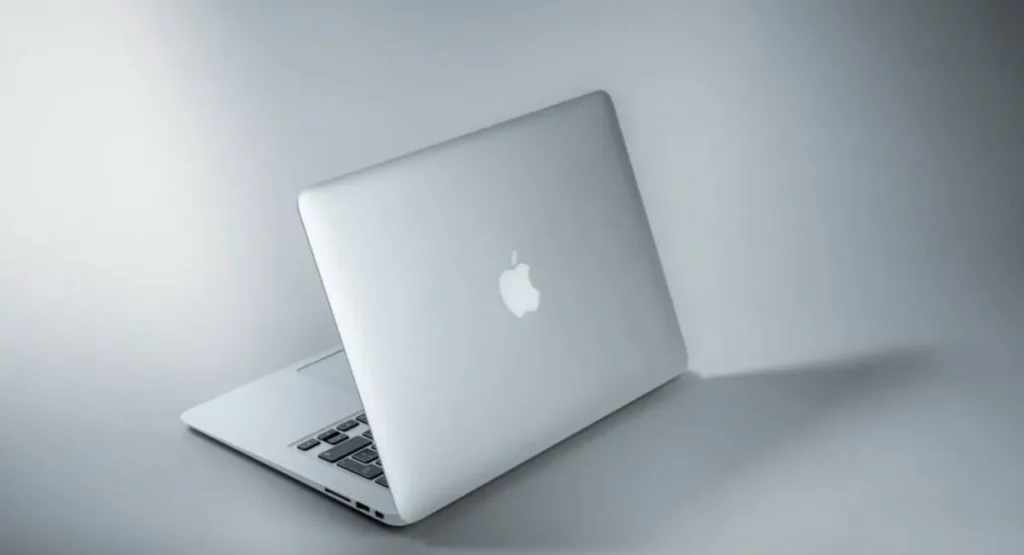 Silver MacBook closed on a light surface, the Mac setup these free AI HR tools run on