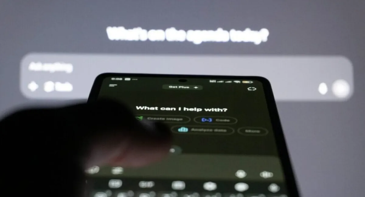 Person typing a question into an AI chatbot on a smartphone, the moment an AEO tool for AI product teams measures