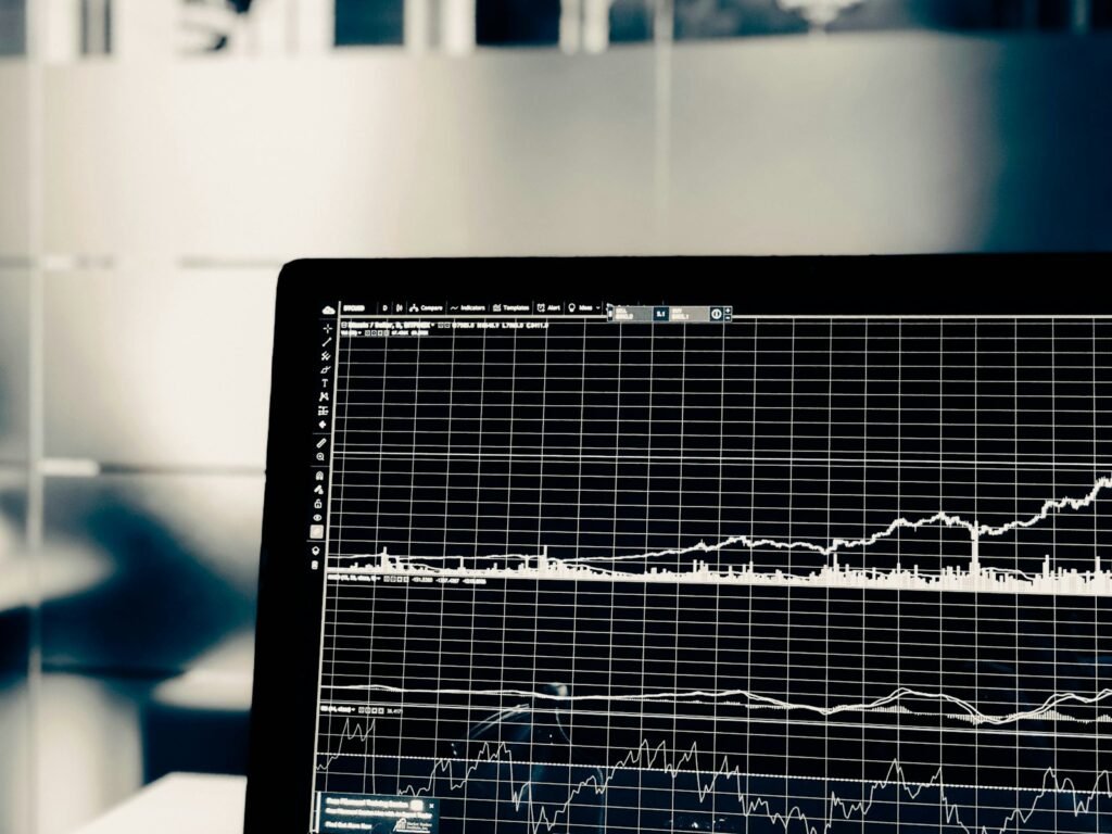 Financial charts on a monitor representing the best AI tools for RIA firms and adviser compliance workflows