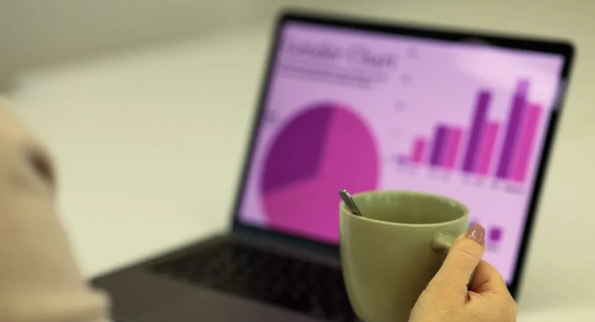 Pie chart and bar chart dashboard open on a laptop, the kind of report tools for monitoring AI Overviews produce