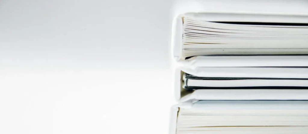 Best AI Search Optimization Tools for Data Accuracy 2025 Stack of organised white binders, representing the checked facts AI search optimization depends on for accuracy