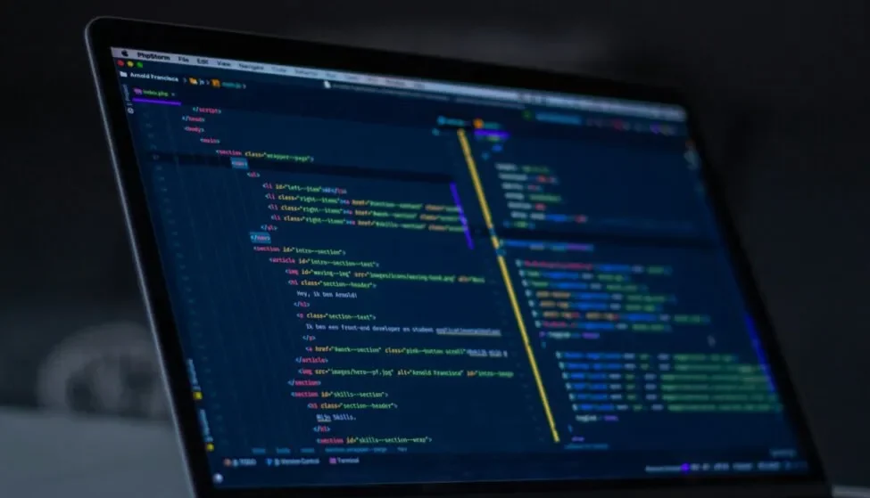 Laptop showing code in a dark editor, where production LLM evaluation runs are wired into the application