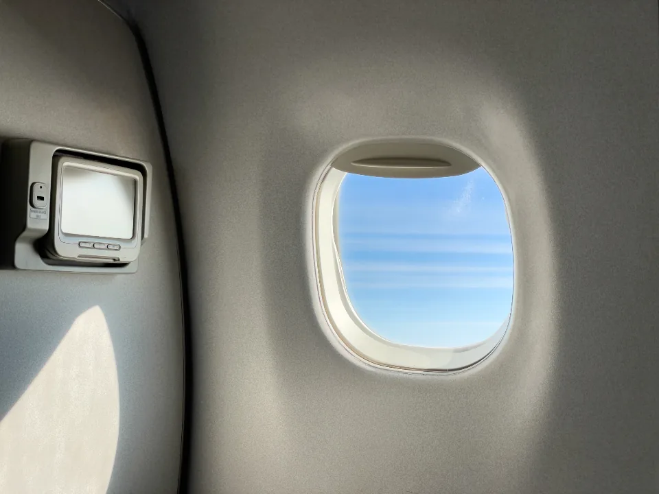 Airplane window in flight, where airplane mode shows whether on-device AI really works offline