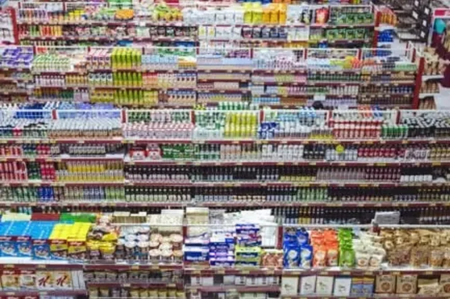 Working through AI tools small businesses 2026 Supermarket shelves stocked with products, the inventory-heavy retail setting many small businesses run AI tools in