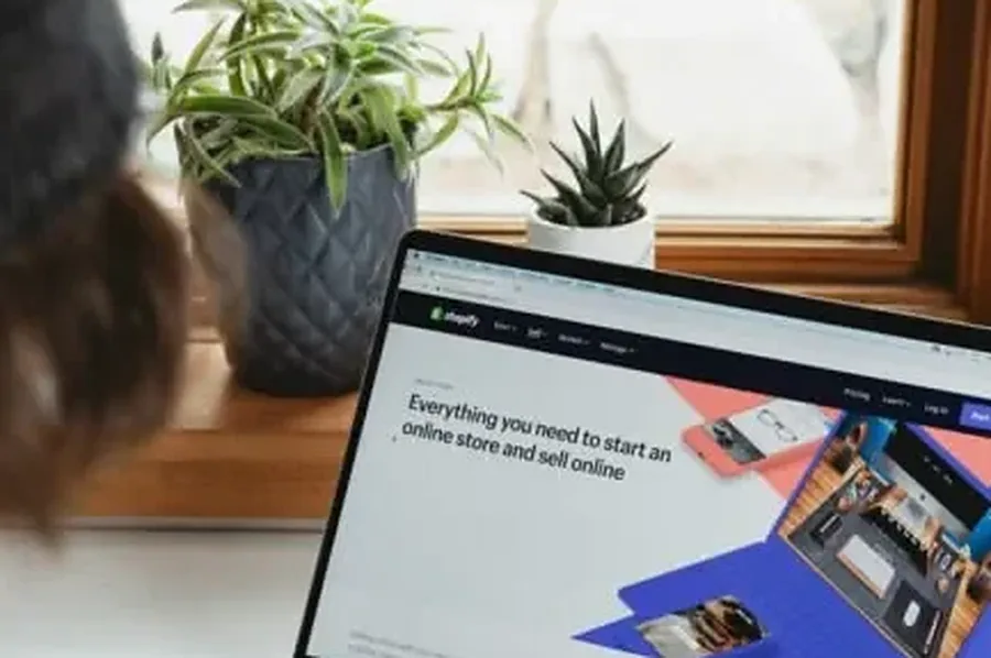 Working through AI visibility tools mid market companies Laptop showing an ecommerce storefront on a desk, a mid-market brand checking how AI search presents it