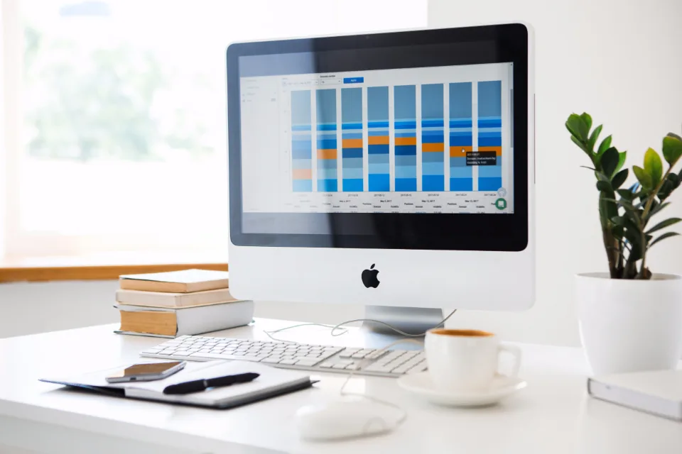 Desktop workstation with charts Desktop workstation showing charts on a tidy desk, comparing self-hosted AI costs with paying for an API
