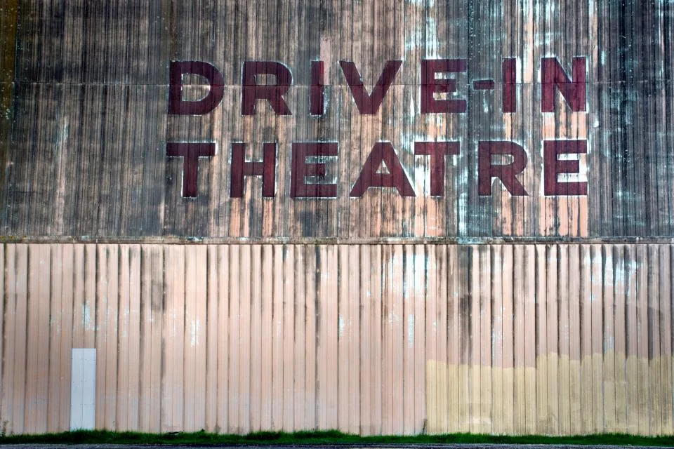 Old drive in theatre sign Faded drive-in theatre sign; old footage like this can be restored with local AI upscaling