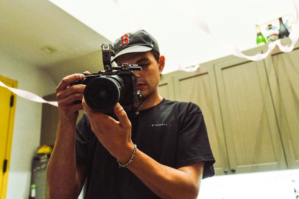 Videographer filming indoors Videographer filming indoors; footage that can stay private with local AI editing